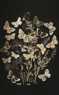 A cluster of pale butterflies and leaves on black