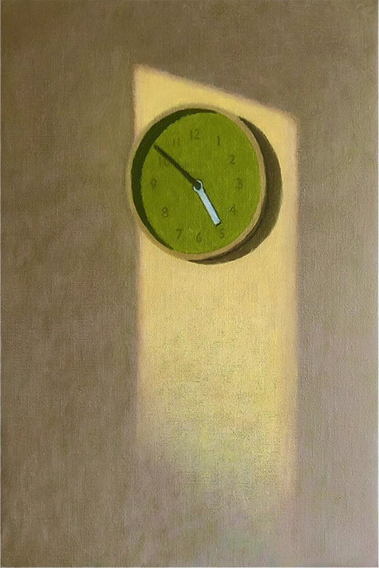 A round green clock lit by a shaft of light on an olive wall