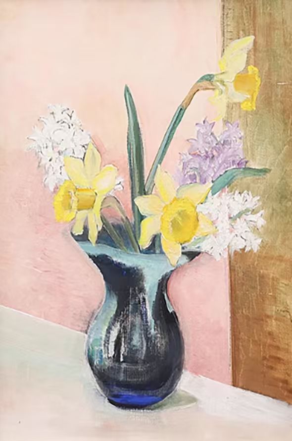 Daffodils and hyacinths in a dark blue glass vase on pink