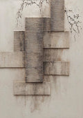 Textured grey blocks stacked beside fine bare branches
