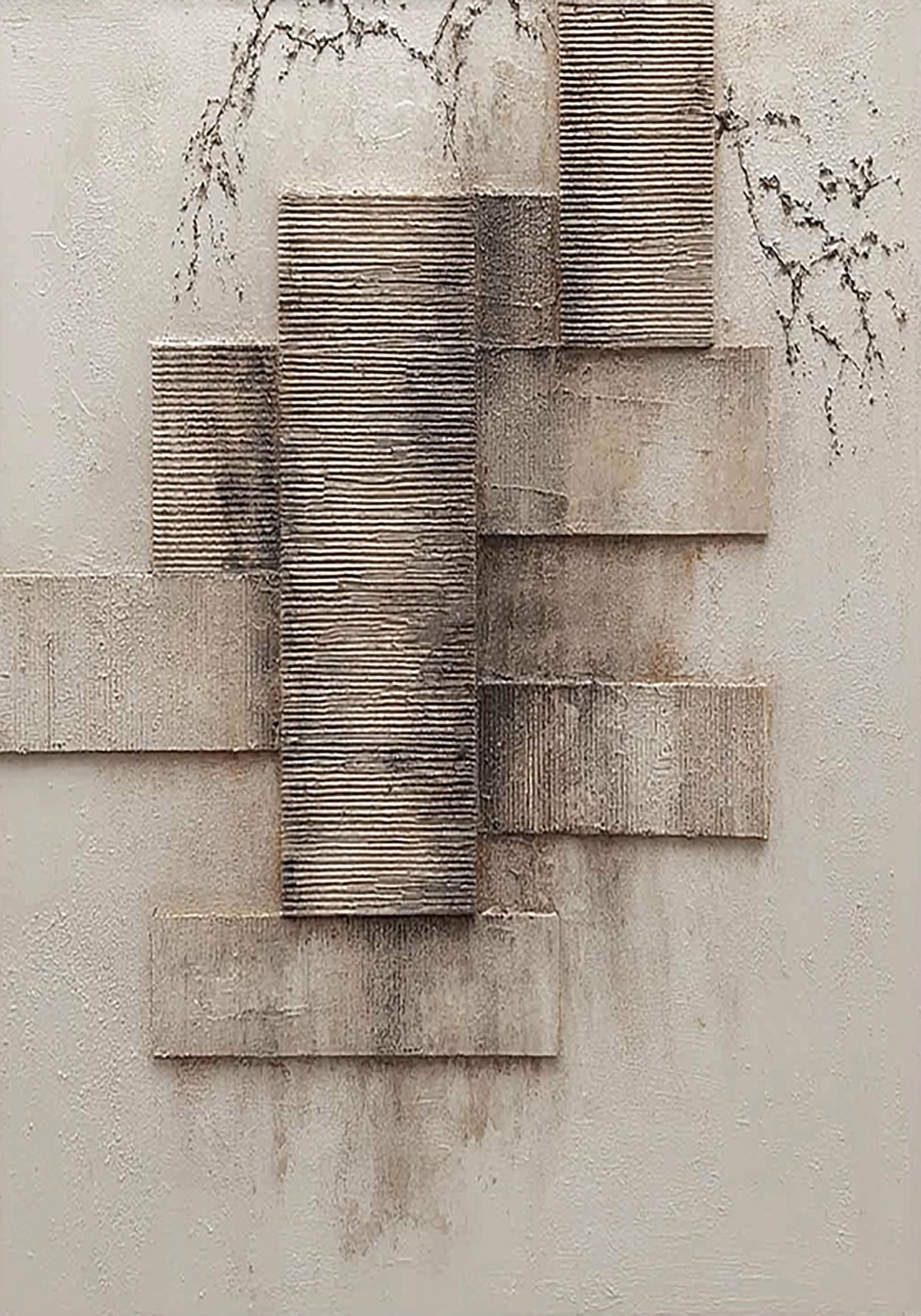 Textured grey blocks stacked beside fine bare branches