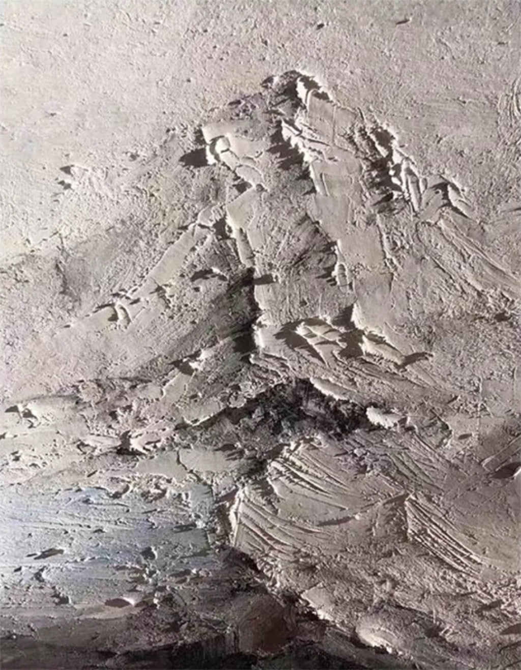 A grey mountain range sculpted in rough plaster texture