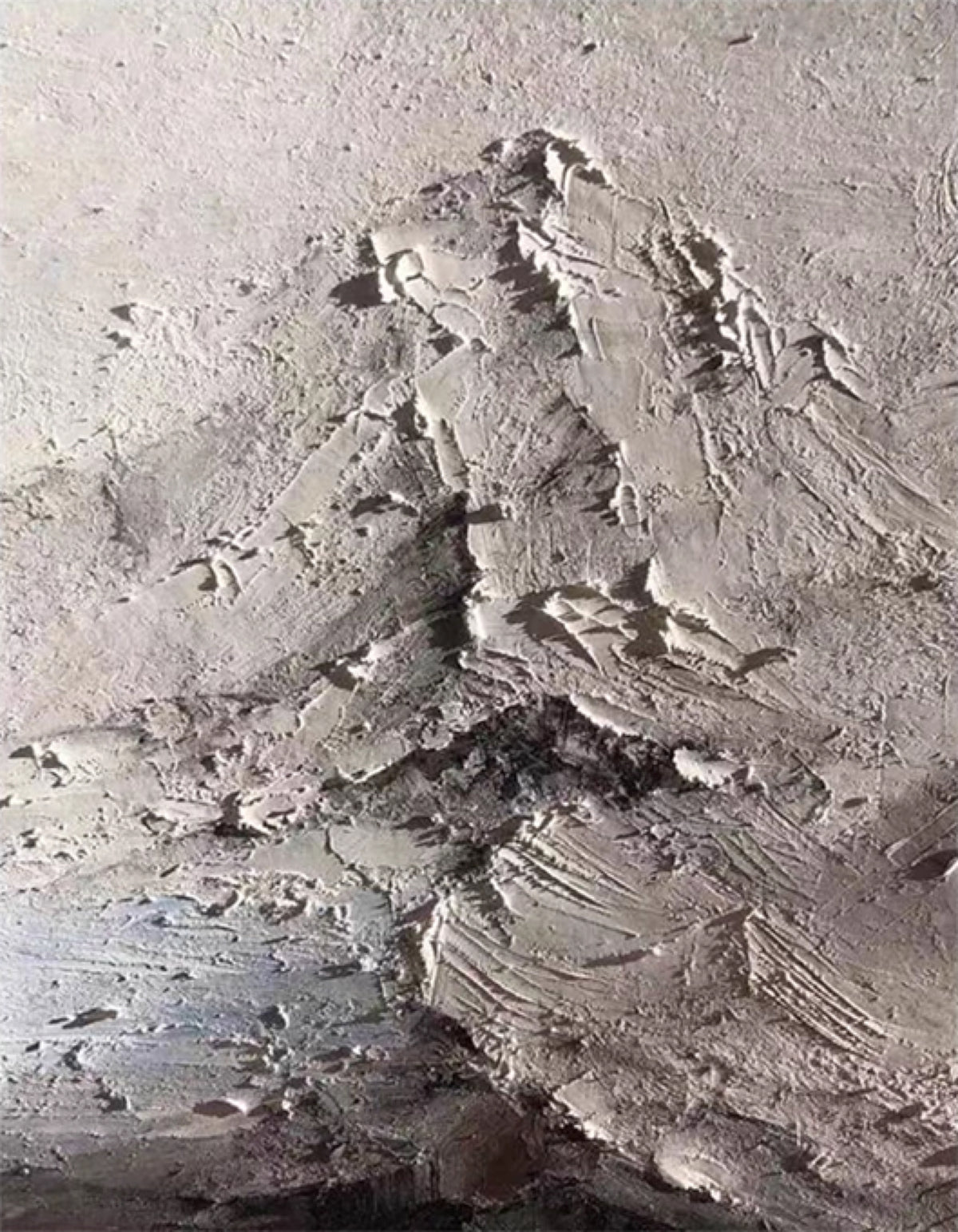 A grey mountain range sculpted in rough plaster texture
