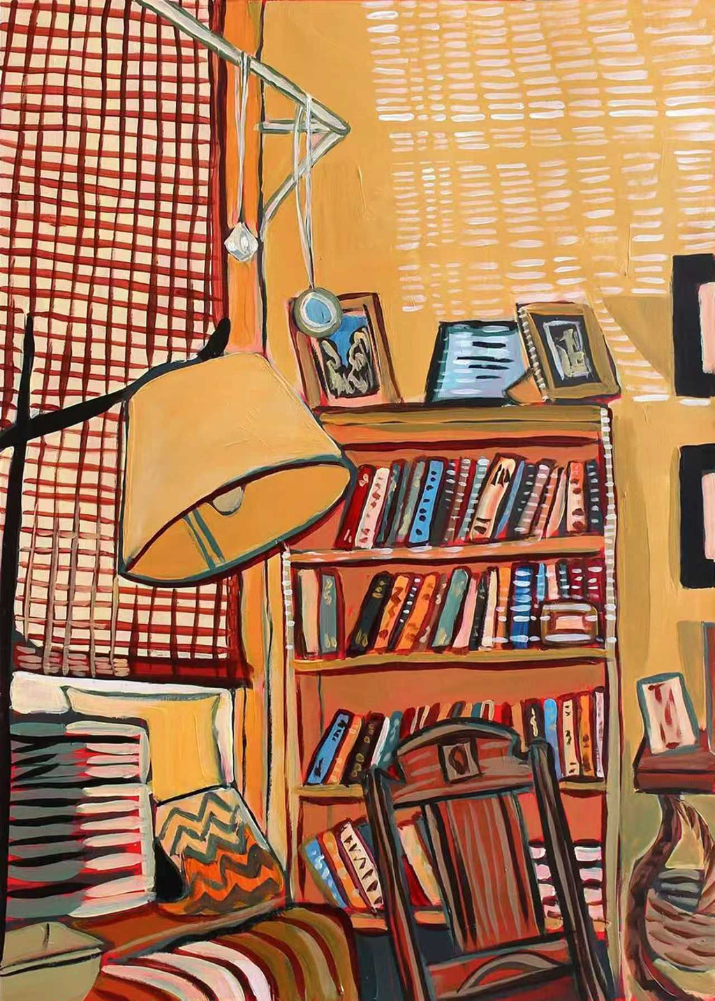 A lamp and crowded bookshelves in a patterned reading corner