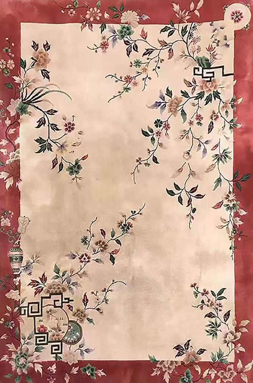 A cream rug of scattered blossoms framed in deep red