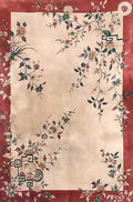 A cream rug of scattered blossoms framed in deep red