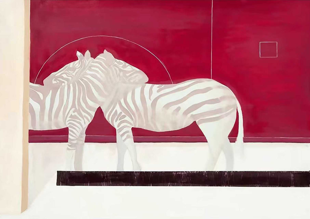 Two pale zebras standing before a deep crimson wall