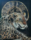 A leopard lying before a gold ornamental halo on black