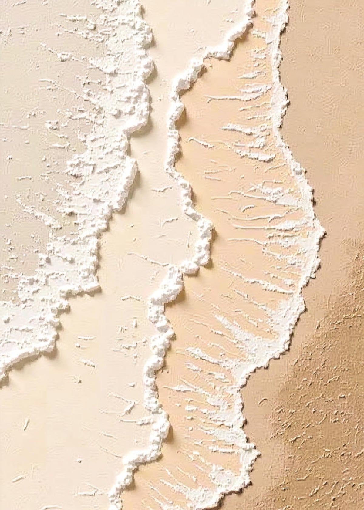 Two lines of white foam washing over pale peach sand