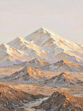A snowy peak and ridges catching warm evening light