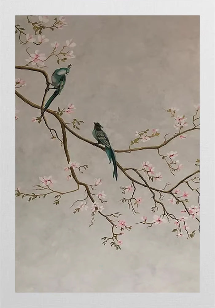 Two dark birds on a blossoming plum branch on grey
