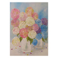 Pink, blue and lilac hydrangeas in two clear vases