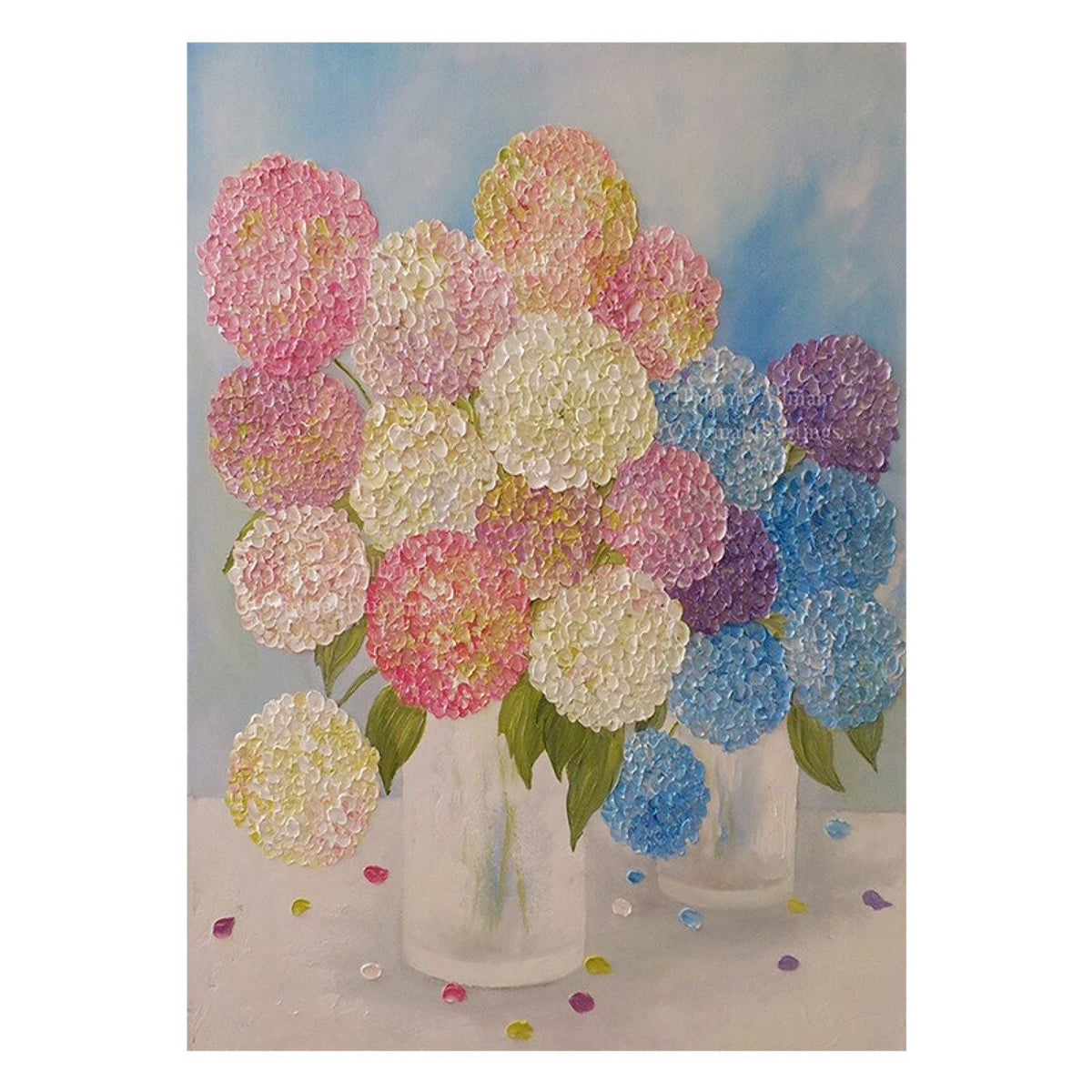 Pink, blue and lilac hydrangeas in two clear vases
