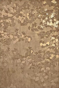 Falling gold leaf flakes on warm brown