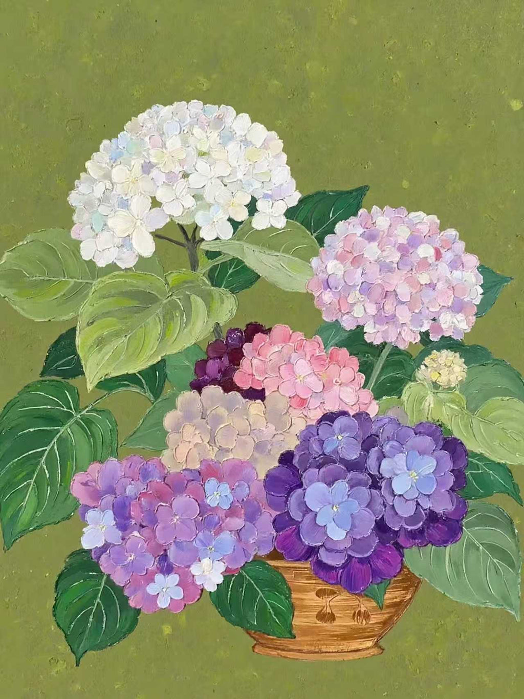 White, lilac and purple hydrangeas in a basket on sage green