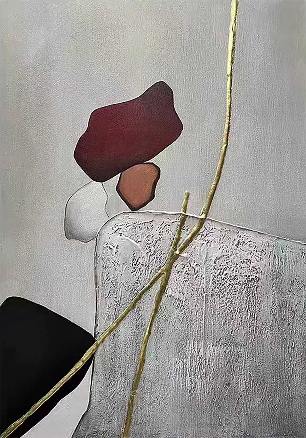 Red, white and black stones balanced on grey, crossed by a gold line