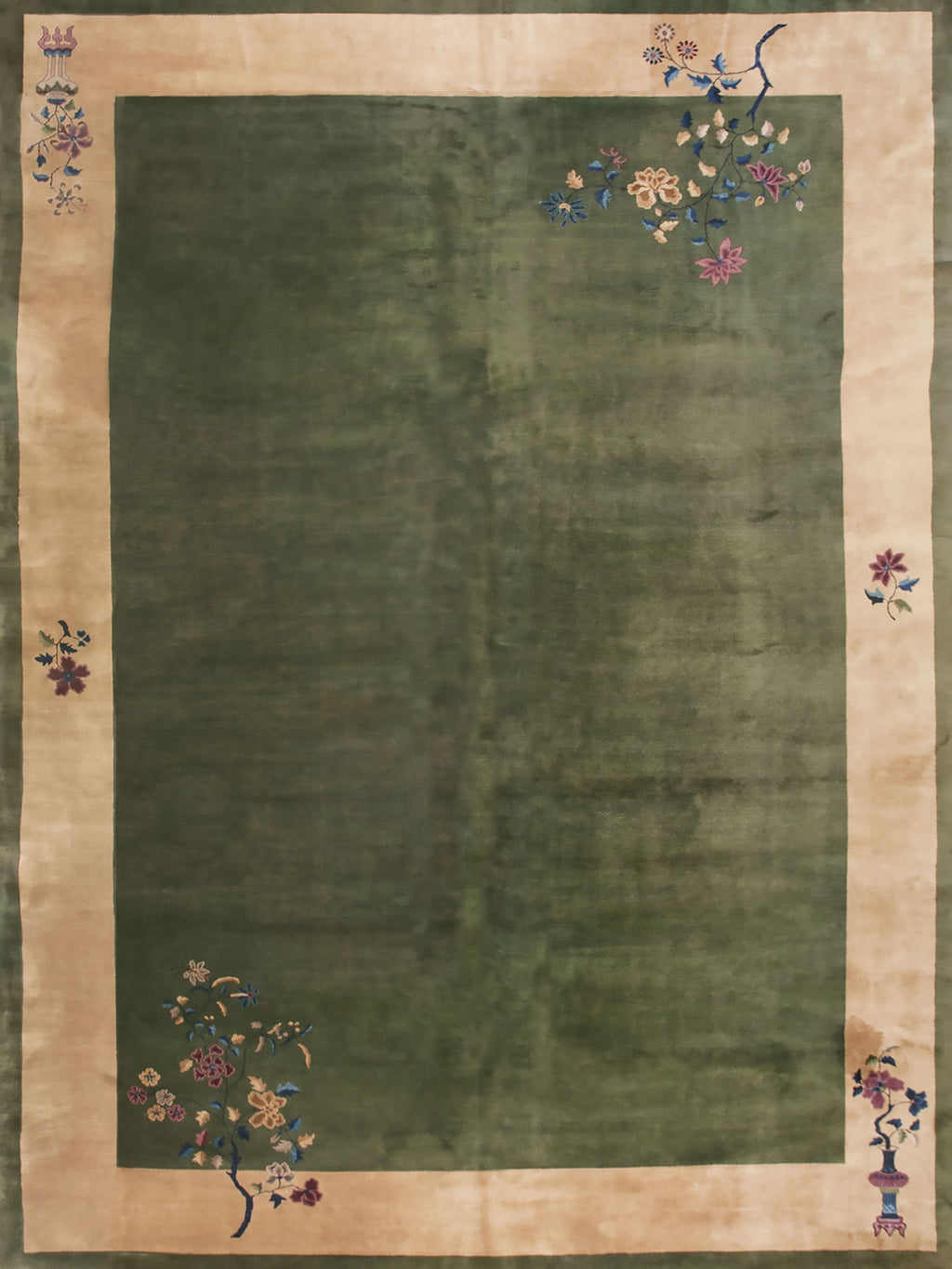 A deep green field inside a pale floral border, like an old rug