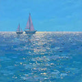 Two sailboats on a sparkling deep-blue sea under a clear sky