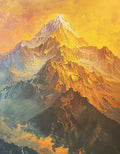 A rugged peak lit orange and gold above misty slopes