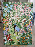 A blue chair among a wall of roses and garden blooms