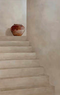 Pale plaster stairs with a terracotta pot on a ledge