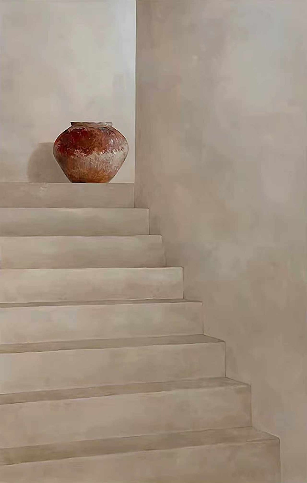 Pale plaster stairs with a terracotta pot on a ledge