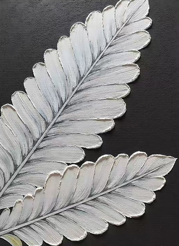 Silver fern fronds sculpted on black
