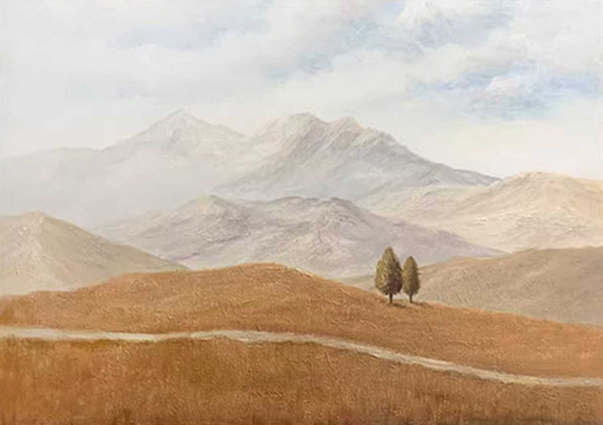 Two small trees on golden hills before misty mountains