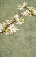 A spray of white lilies across a soft green ground