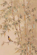 A small bird among pale bamboo stalks on warm tan