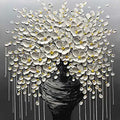 A cascade of white blossoms from a dark vase on grey