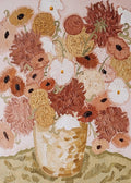 Rust and coral dahlias in a sculpted vase