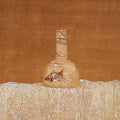 A small goldfish painted on a pale bottle on rust