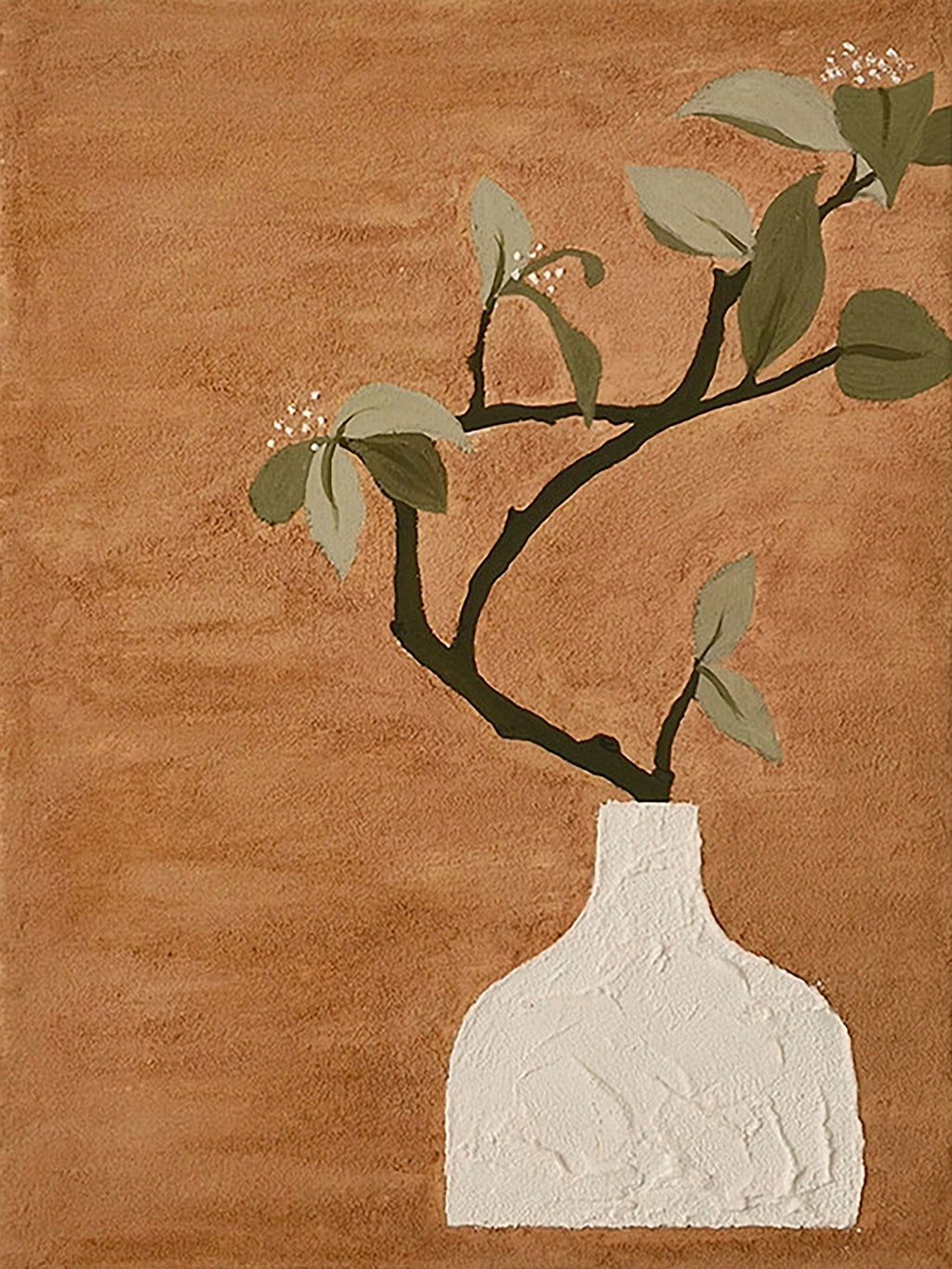 A leafy branch in a textured white vase on terracotta