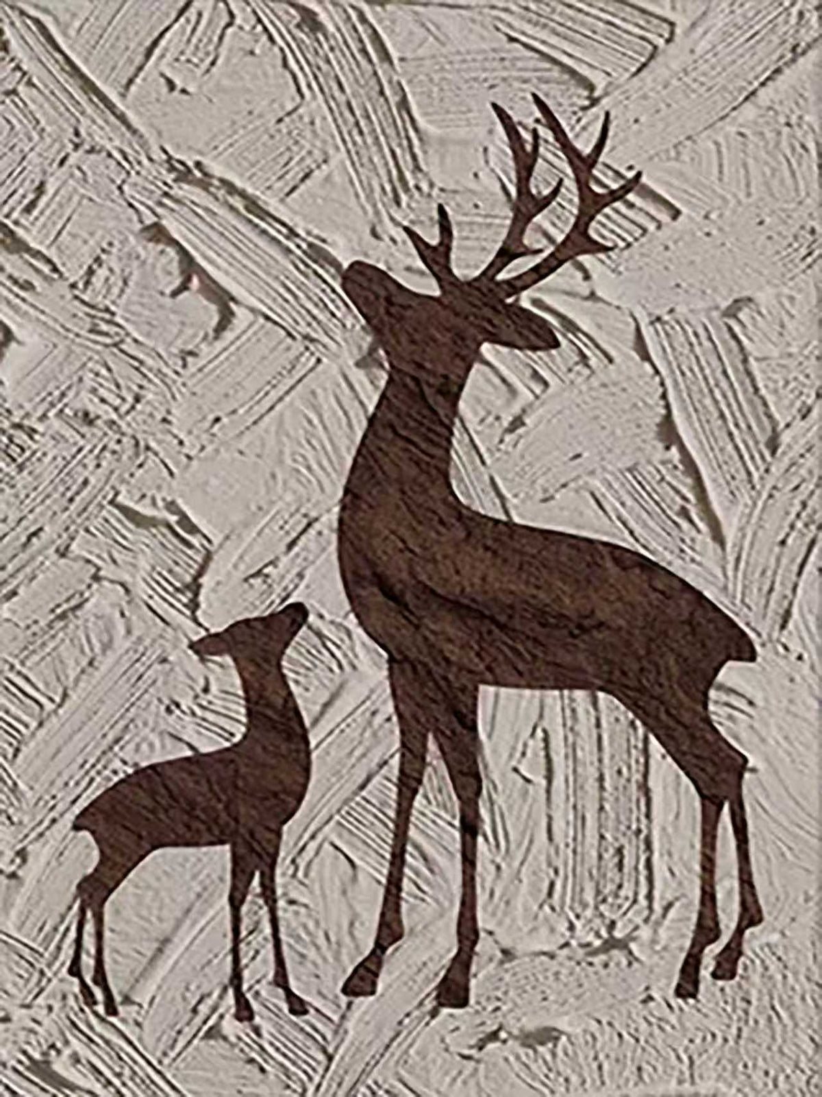 A brown stag and fawn silhouetted on rough cream texture