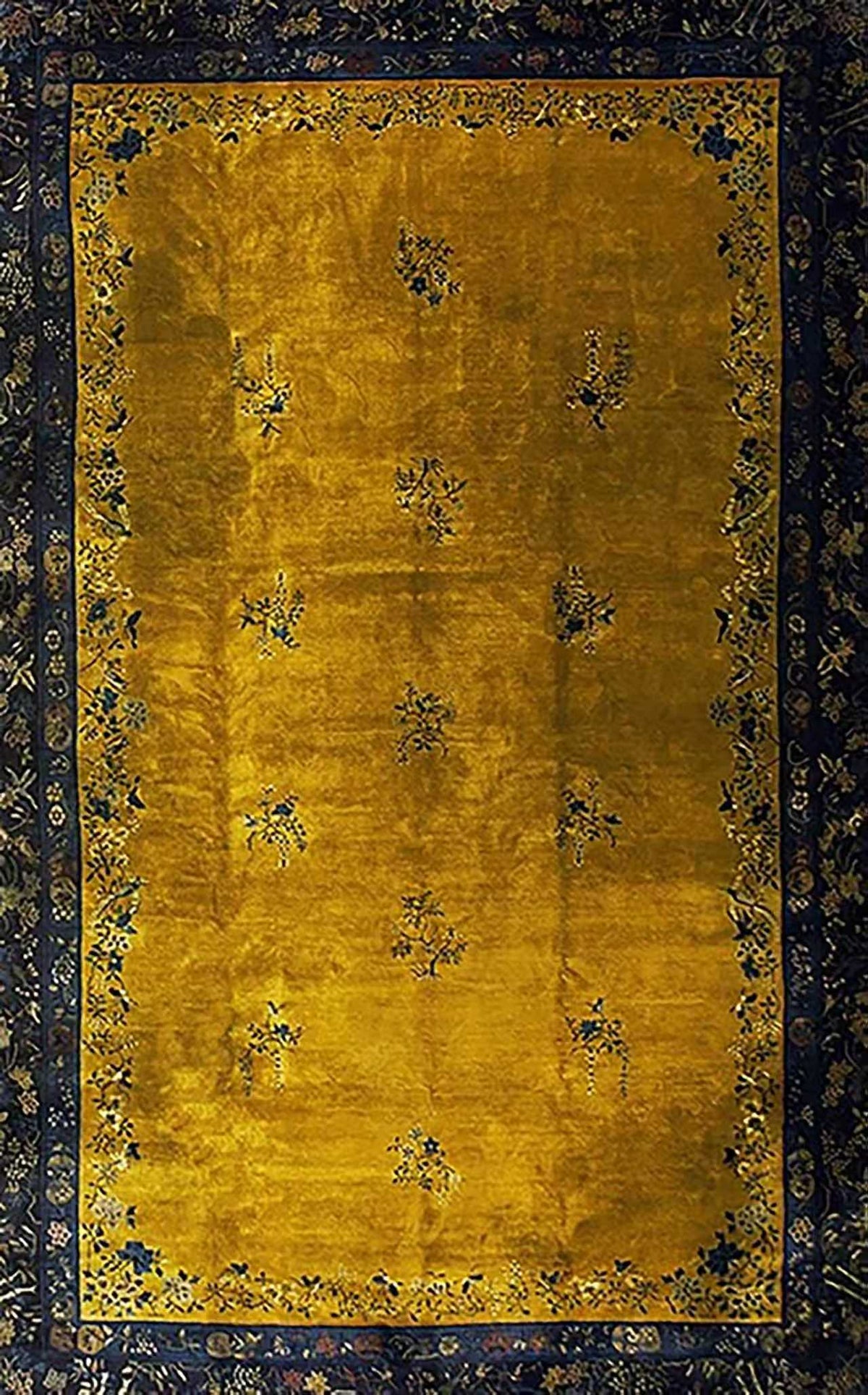 A mustard field framed by a navy patterned border, like an old rug