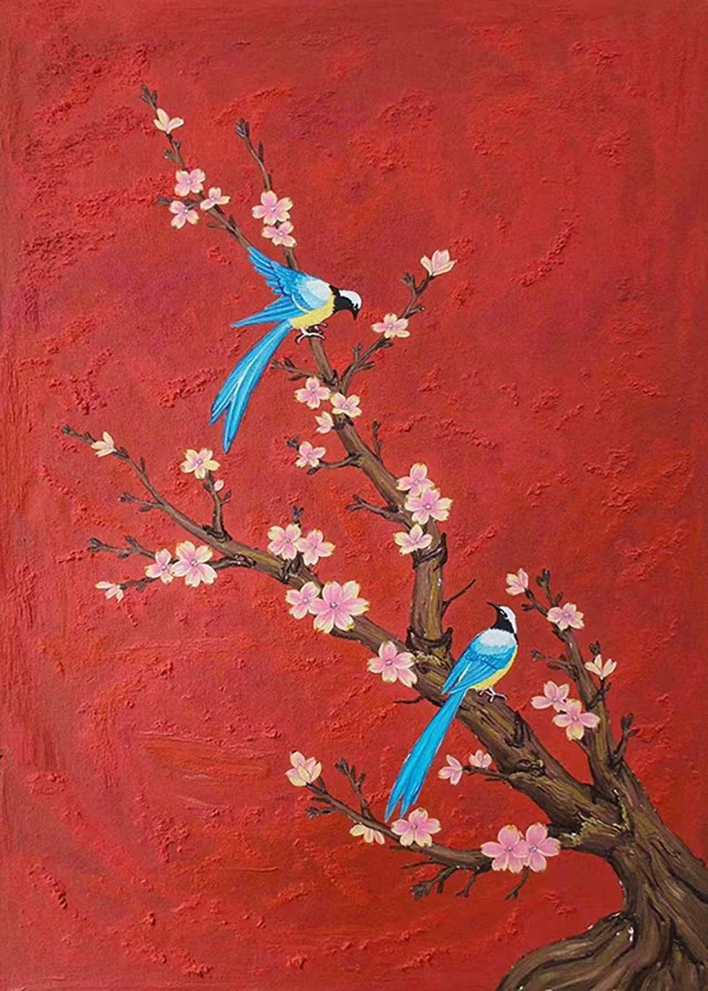 Two blue birds on a blossoming branch against bold red