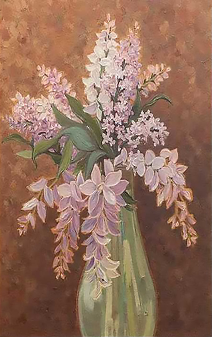 A spray of lilac in a slim glass vase against warm brown