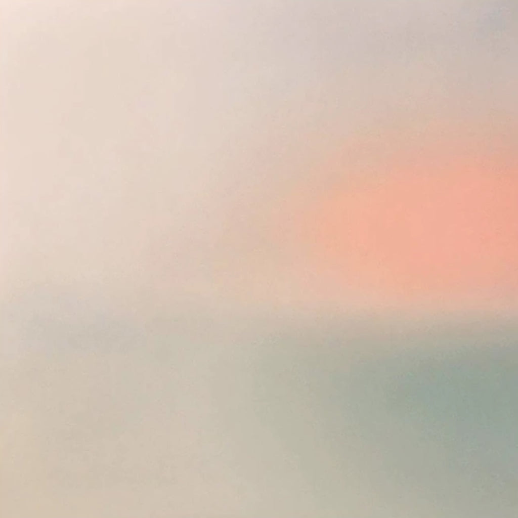 A soft coral glow bleeding into misty grey-blue