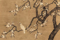 A white bird perched on a gnarled plum-blossom tree on aged silk