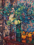 A vivid bouquet in glass with oranges on a dark patterned table