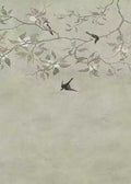 Swallows darting through pale branches on grey-green