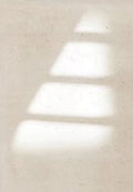 Steps of soft window light on a linen-beige wall