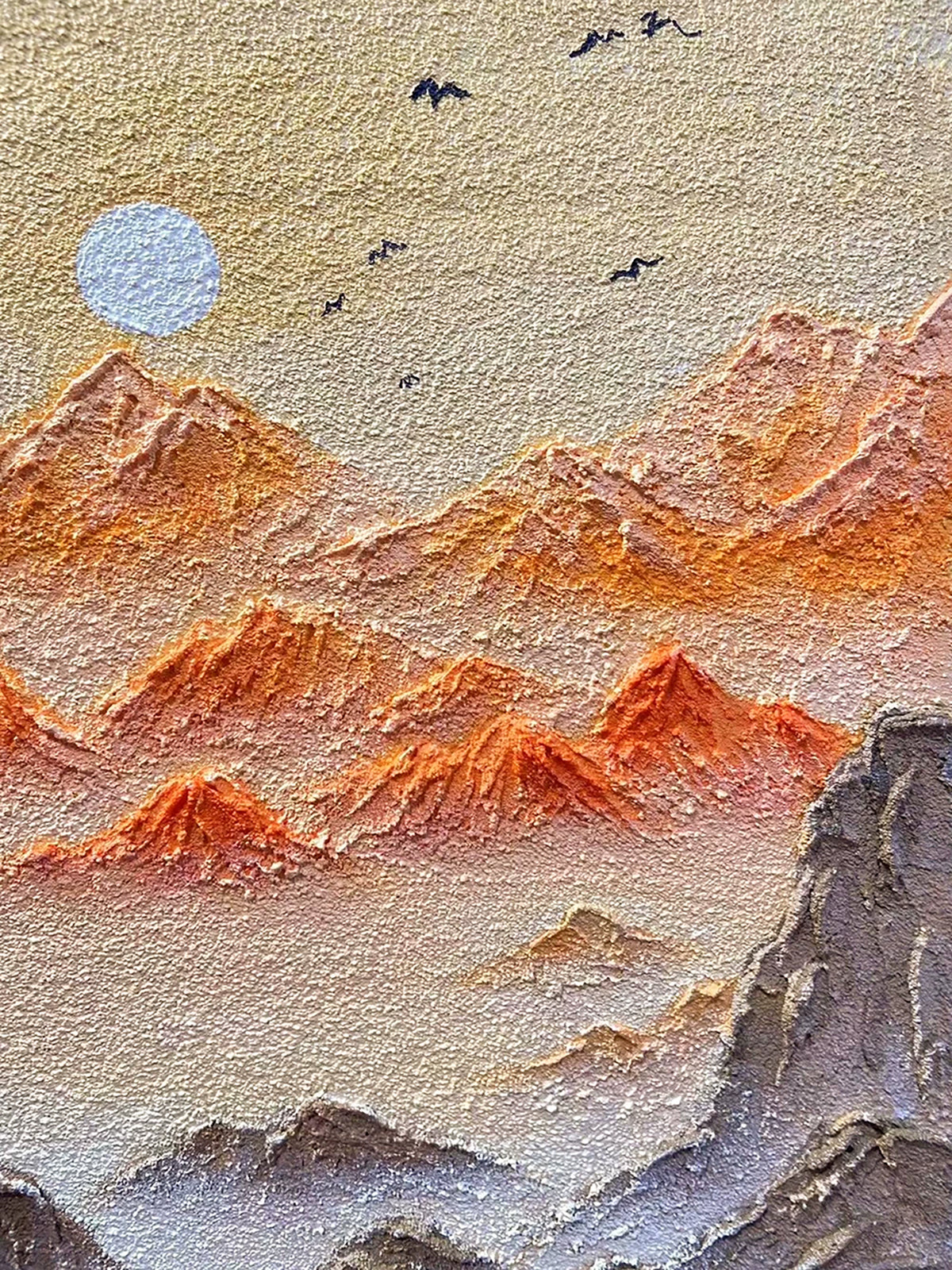 Sculpted orange ridges with birds and a pale moon