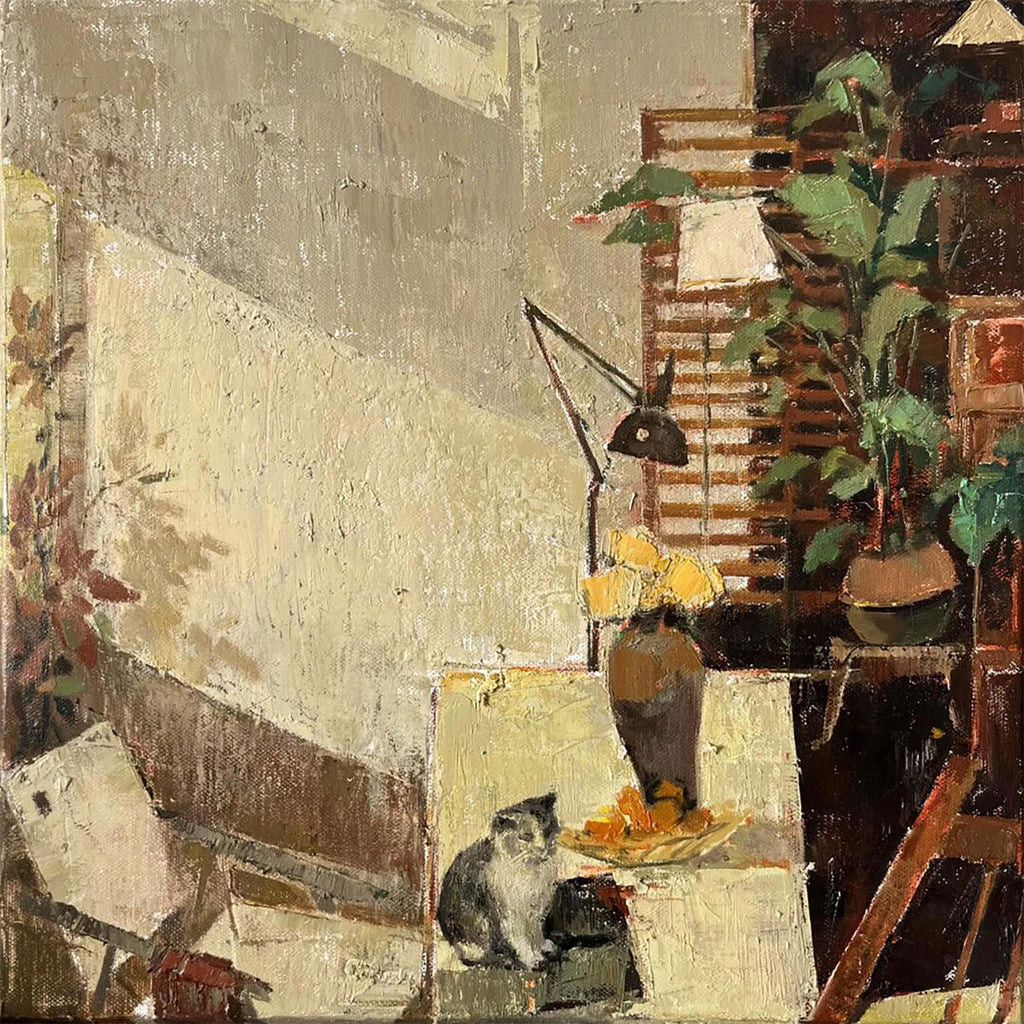 A cat among plants, lamps and canvases in a cluttered sunlit studio