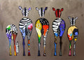 Five zebras seen from behind, patched with bright colors