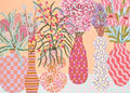 A row of pink patterned vases holding playful bouquets