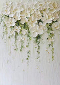 White blossoms cascading in thick relief with trailing green vines