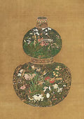 A gourd-shaped vase covered in fine botanical patterns on gold