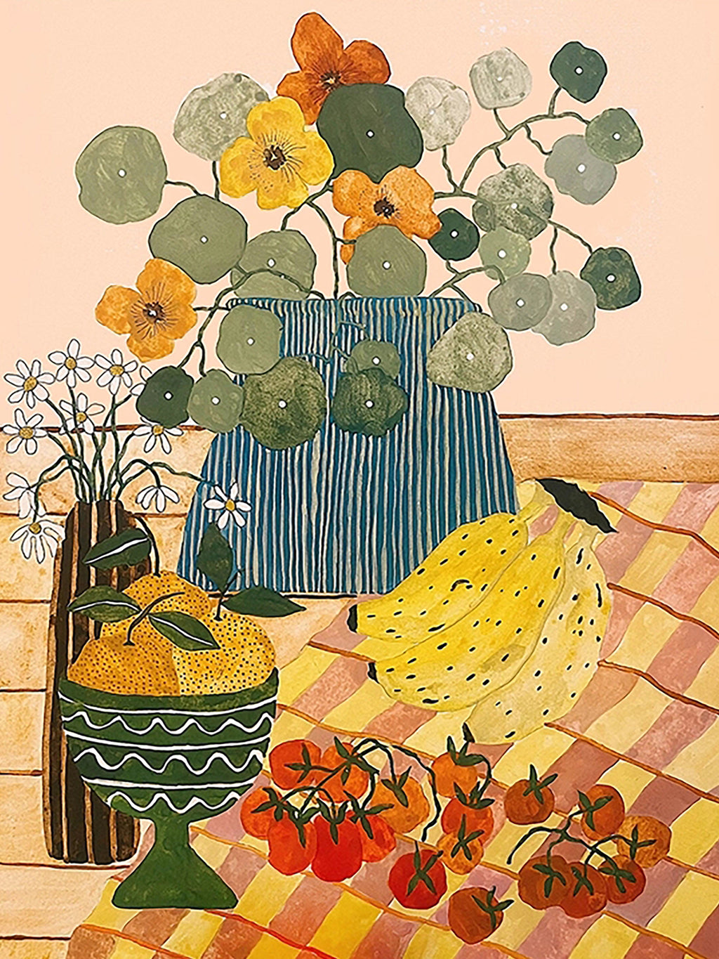 Bananas, tomatoes and a vase of flowers on a checked tablecloth